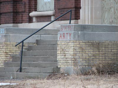 graffiti on the front of the gymnasium with names of units stationed at Ft. Snelling in the first half of the 20th century